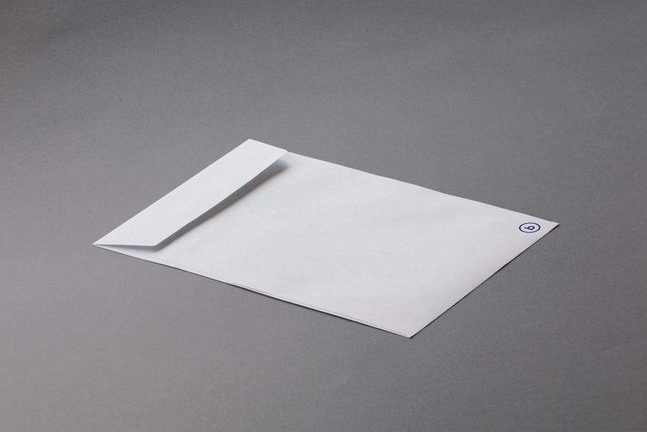 Simple white envelope on a gray background offering ample copy space.